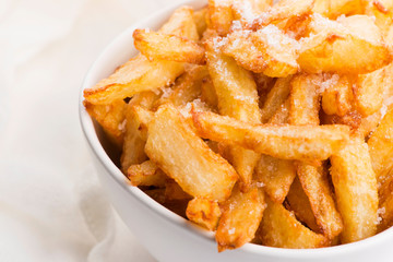 Bowl of potatoe fries on a white background