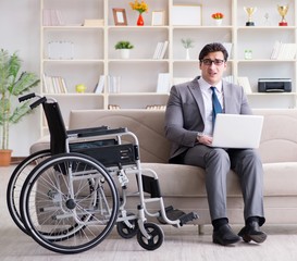 Dsabled businessman on wheelchair working home