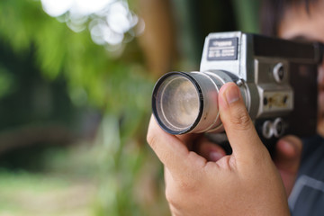 Hand holding old 8mm film video recorder