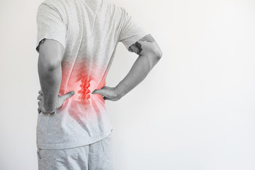 Office syndrome, Backache and Lower Back Pain Concept. a man touching his lower back at pain point - 306623885
