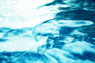 The smooth natural blue water background with bokeh  abstract on the sea or ocean,vintage and soft colored blur.