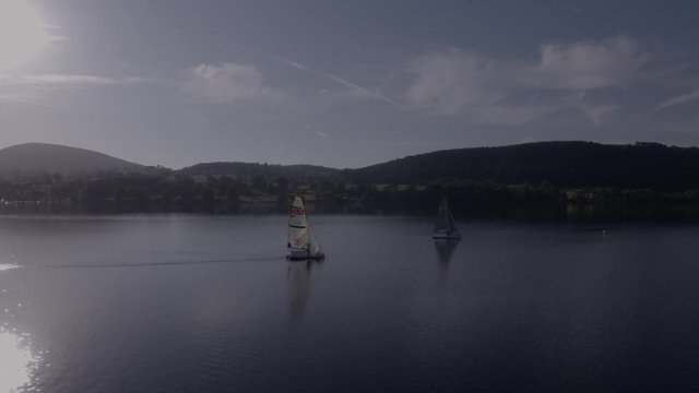 a sailing competition on ullswater on a hazy, sunny summers evening