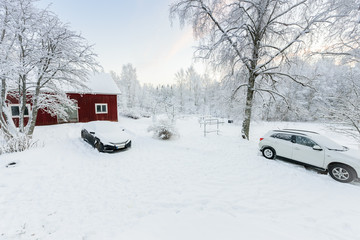 The house and car in the forest has covered with heavy snow and clear blue sky in winter season at...