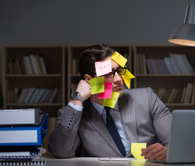 Businessman staying late to sort out priorities