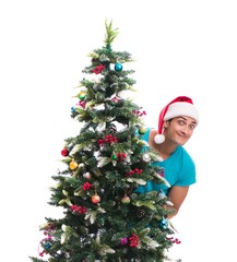 Young man decorating christmas tree isolated on white