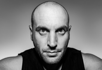 black and white portrait of a bald man