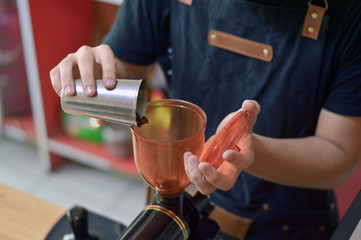 Fototapeta na wymiar close up barista hand pouring coffee bean to grinder machine