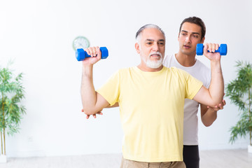 Old man doing exercises indoors