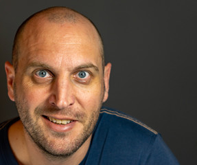 portrait of bald man with blue eyes