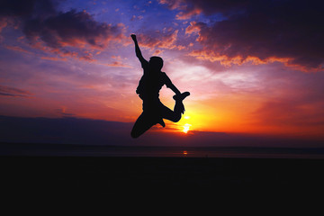 Silhouette of a man jumping on the beach