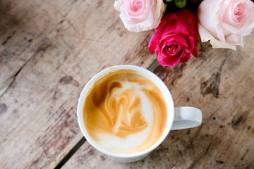 Cup of coffee latte and flowers.