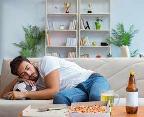Man eating pizza having a takeaway at home relaxing resting