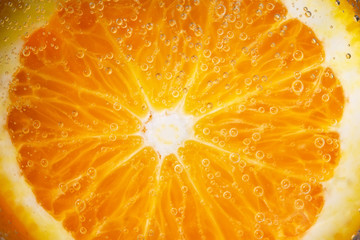 Macro of ripe orange, small depth of field. Blurred fruit background