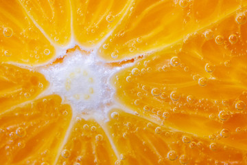 Orange slice and the external part close up. Orange pulp and peel. macro image. juicy fruits under water