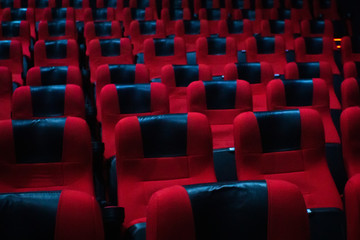 Cinema theater hall inside, red chairs. Empty cinema hall