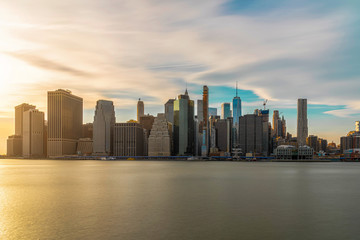 New york Cityscape with Brooklyn Bridge over the east river at the evening time, USA downtown skyline, United states of America, Architecture and building with tourist concept