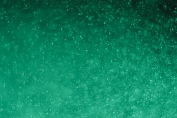 Abstract bokeh lights with light green background