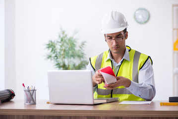 Young male architect working in the office