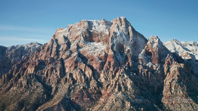 Aerial pullback shot of snow covered Mount Wilson mountains in Red Rock Canyon