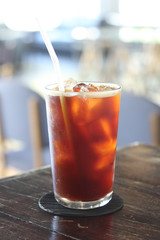 Iced americano coffee with ice on table in cafe.