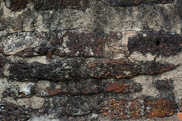 Grunge dirty old brick stone wall exterior on ancient temple architecture in Ayutthaya, Thailand. Weathered textured pattern background with copy space for text