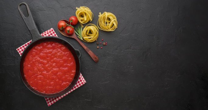 Cinemagraph loop. Bubbling hot tomato sauce for pasta, cooking in pan. Top view