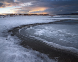 frozen river and beautiful sunset
