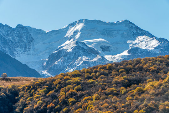 High snowy mountains and glacier in North Ossetia in the fall.