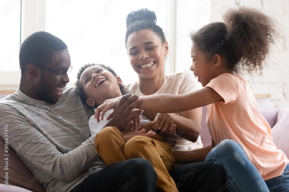 Wall mural Overjoyed biracial family with kids have fun at home