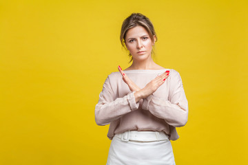 No more, this is the end. Portrait of serious stubborn young woman with fair hair in casual blouse...
