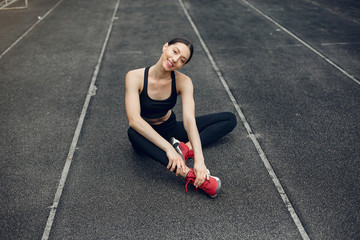 Beautiful girl at the stadium. Sports girl in a sportswear.