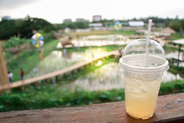 A glass of water and rice fields in the setting sun