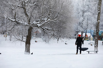 Winter walk with an umbrella.Man in a coat with an umbrella, walk against the backdrop of the winter landscape, winter view