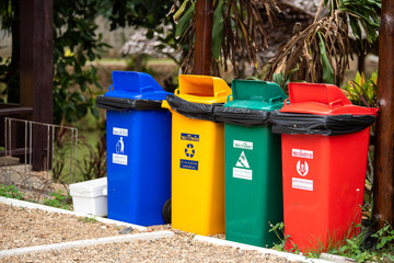 Multiple colored plastic buckets for garbage separation in the park