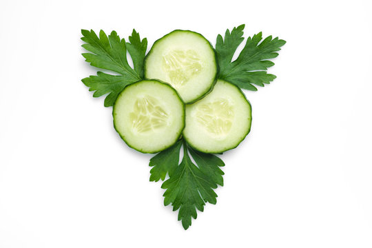fresh cucumber slice with parsley, isolated on a white background. top view