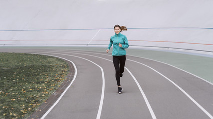 Young adult sporty woman  running on sport training in city