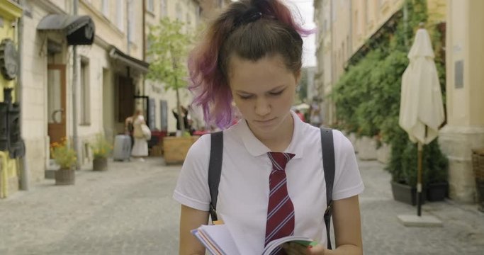 Beautiful student teenager girl with school notebook.