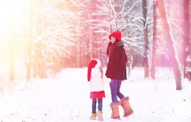 A winter fairy tale,in the forest. A girl on a sled with gifts on the eve of the new year in the park. Two sisters walk in a New Year's park and ride a sled with gifts.