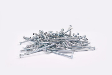 Construction materials.Gray iron nails on white background.