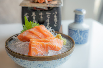 Fress fresh traditional Japanese healthy food name’s sashimi salmon served on ice in a bowl in a Japaneses restaurant..