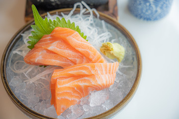 Fress fresh traditional Japanese healthy food name’s sashimi salmon served on ice in a bowl in a Japaneses restaurant..