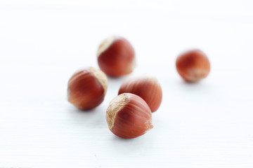 Obraz na płótnie Canvas Hazelnuts on white wooden table with clipping path