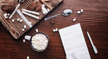 Winter breakfast. A cup of hot chocolate with marshmallows and freshly baked cookies. Gingerbread cookie and coffee.