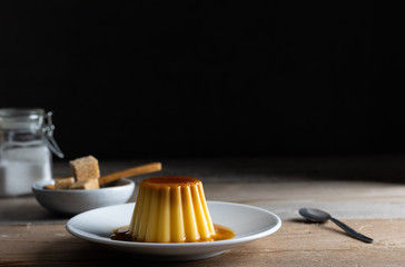 Homemade creme caramel desert on a dark background