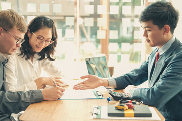 couple buying renting house car signing mortgage insurance purchase order contract agreement with realtor real estate agent.