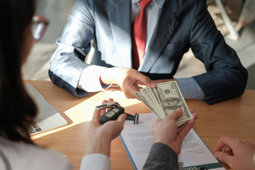 client pay for car. salesman dealer giving key to owner. car sale & dealership in auto business