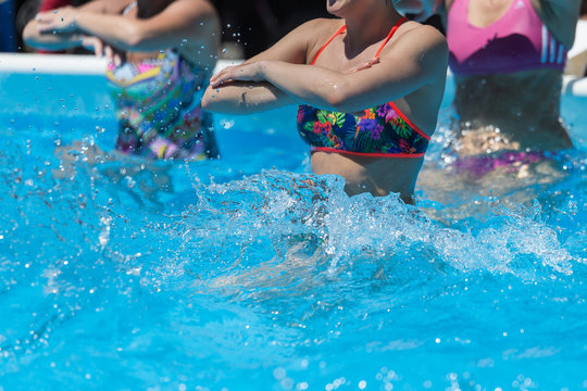 Women Doing Water Aerobics Outdoor in a Swimming Pool