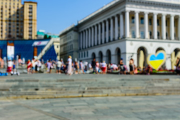 Defocused blurred background of the city street and people silhouettes