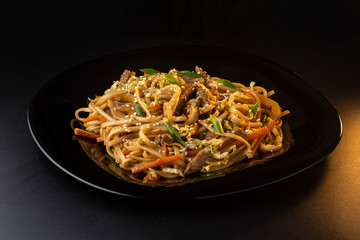 noodles with beef carrots, herbs and sesame seeds