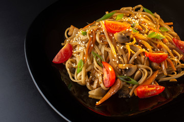 Chinese noodles with tomatoes, mushrooms and herbs, macro